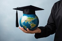 Graduation globe holding planet. 