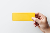 Holding yellow paper text. AI generated Image by rawpixel.