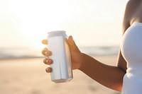 Holding beach drink refreshment. 