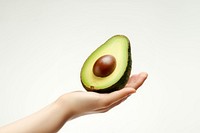 Avocado holding fruit plant. AI generated Image by rawpixel.
