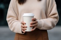 Coffee cup holding drink. 