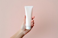 Cosmetics holding toothpaste sunscreen. AI generated Image by rawpixel.