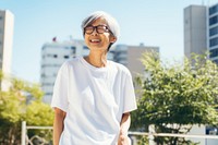 Standing outdoors glasses smiling. 