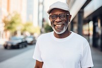 Standing outdoors glasses smiling. 