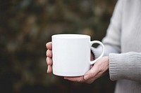 Mug holding coffee drink. 