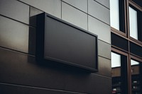 Sign outdoors black wall. 