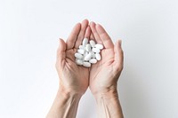 Medicine holding white pill. 