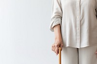 Holding adult white cane. 