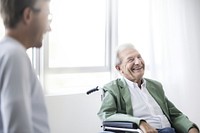 Senior man in wheelchair smiling. 