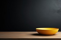 Yellow table black bowl. 