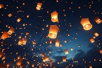 Floating lanterns in night sky. 