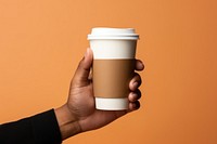 Coffee cup holding latte. AI generated Image by rawpixel.