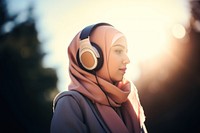 Headphones portrait outdoors hijab. 