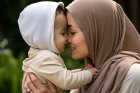 Outdoors toddler kissing hugging. 