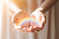 Hand holding rainbow finger. 