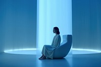 Woman sitting in a white room. 