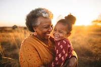 Grandmother grandchild laughing sunset. 