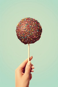 Sprinkles chocolate lollipop holding. 