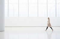 Defocused Woman Walking In large Exhibition Art Hall walking standing day. 