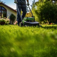 Photo of a man tending to lawn. 