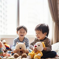 photo of two boys playing with toy stuff animals dolls together. 