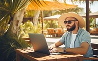 Young man freelancer traveler working online using laptop while traveling on summer vacation. 