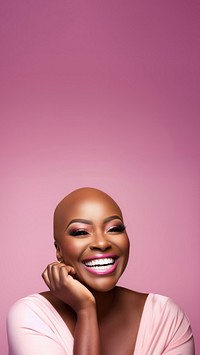 close up face photo of a bald chubby black woman smiling with pink tone makeup.  