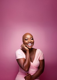 close up face photo of a bald chubby black woman smiling with pink tone makeup.  