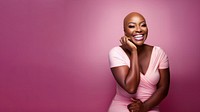 close up face photo of a bald chubby black woman smiling with pink tone makeup.  