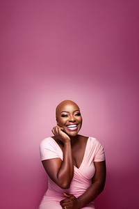 close up face photo of a bald chubby black woman smiling with pink tone makeup.  