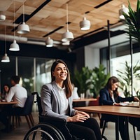 photo of a business woman in wheelchair presenting work in meeting room.  