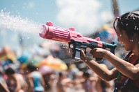 Songkran festival person gun splashing. AI generated Image by rawpixel.