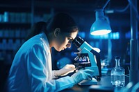 Scientist using microscope female adult concentration. 