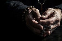 Hands holding a cross hand jewelry finger. 