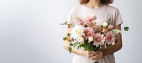 Florist holding flower plant. 