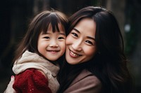 Asian daughter hugging mother child adult smile. 