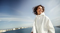 Woman wearing white jacket portrait outdoors smile. 