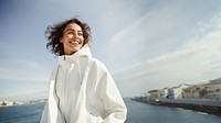 Woman wearing white jacket outdoors adult smile. 