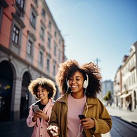 Two female black friends walking headphones listening adult. 