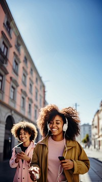 Two female black friends walking headphones adult togetherness. 