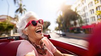 Eldery woman driving laughing glasses car. 