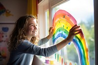 Painting rainbow window. 