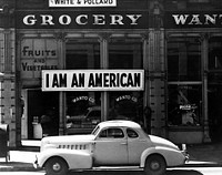 I am an American sign (1942), vintage photo by Dorothea Lange. Original public domain image from the Library of Congress. Digitally enhanced by rawpixel.