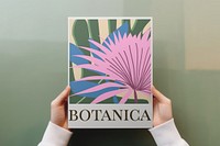 Hands holding botanical poster