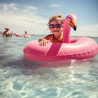 Pink flamingo inflatable sunglasses swimming. 