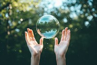 Female hands captured photography sphere bubble. 