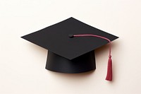 Black graduation hat text paper white background. 