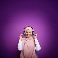 photo of a muslim woman wearing headphones.  