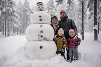 Family sledding snowman footwear outdoors. 