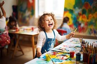 A happy female chubby child showing painted art classroom scene creativity paintbrush. AI generated Image by rawpixel.